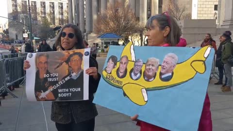 2 women protesting human trafficking outside the #MaxwellTrial