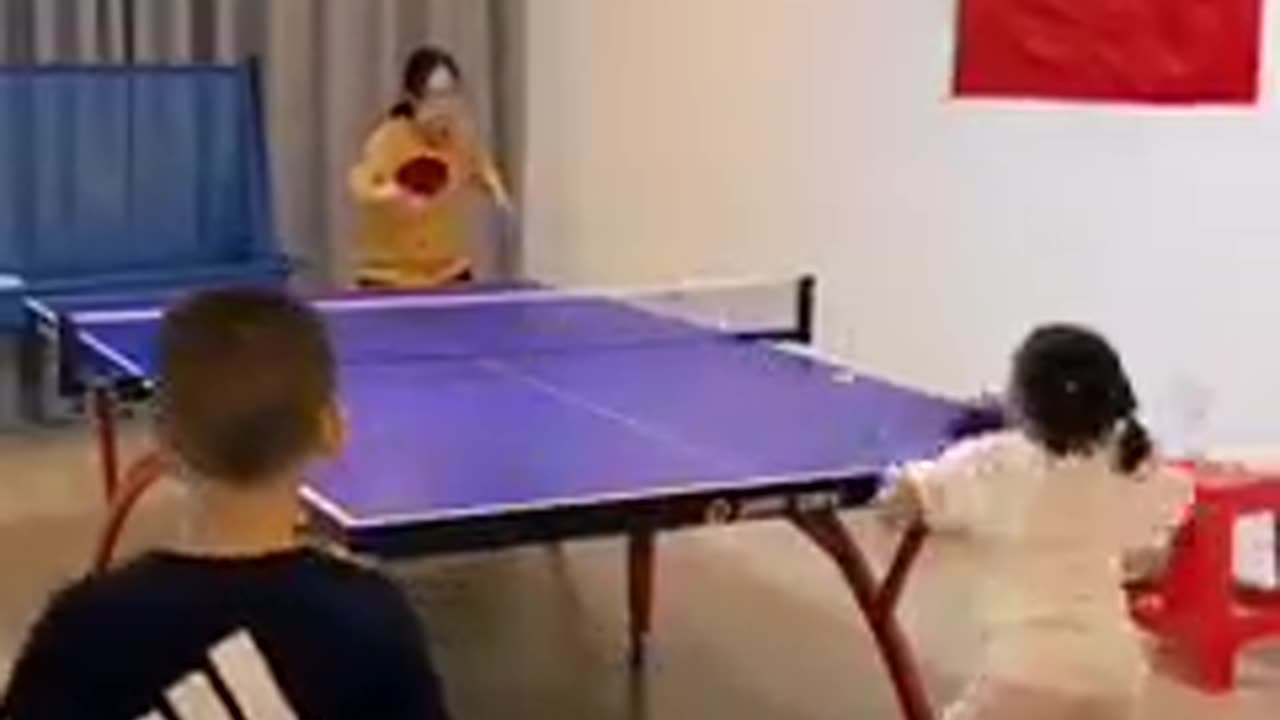 young child playing table tennis