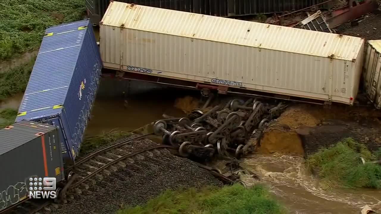 Freight train derails, causes tens of carriages piled up on tracks _ 9 News Australia