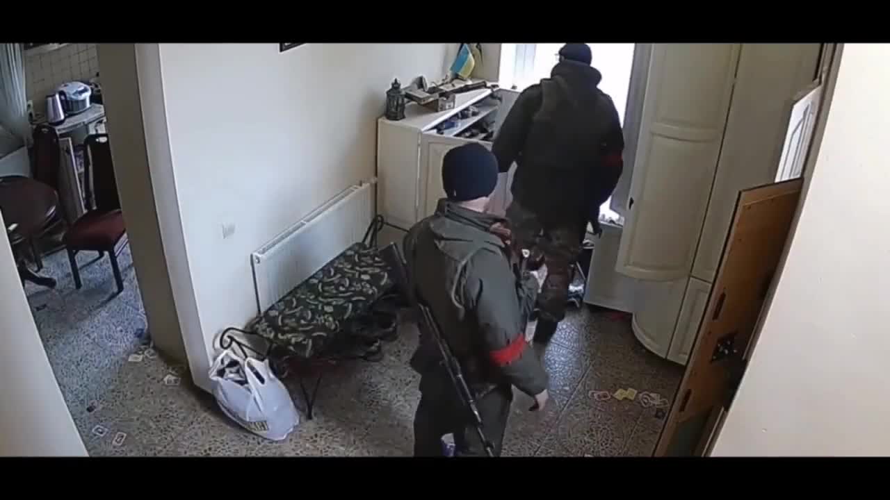 Russian invaders looting a house