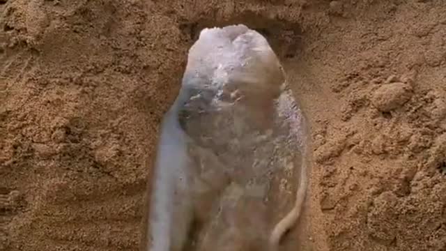 Sand castle with water opening