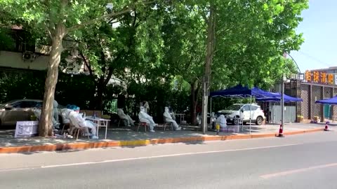 Beijing communities remain in lockdown with closed shops