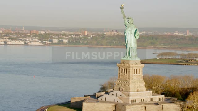 The statue of liberty with the water in the background