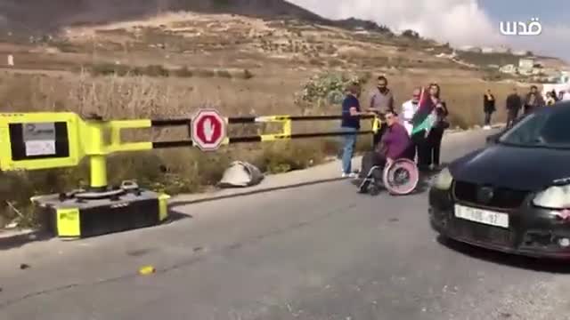 Israeli forces prevent a Palestinian man in wheelchair from crossing