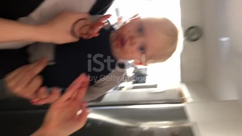 funny baby putting chocolate in his mouth