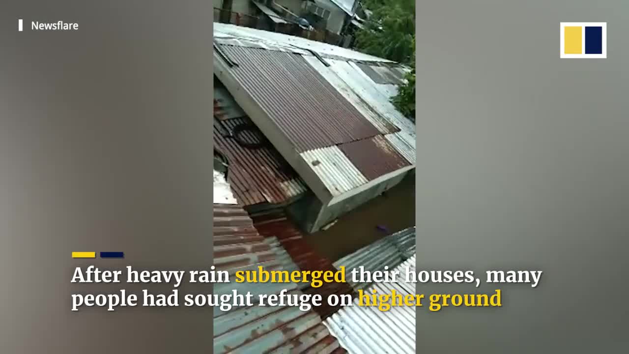 Terrified residents cry for help from roofs of flooded houses in Philippines