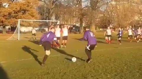 Two boys are playing football in the sunset