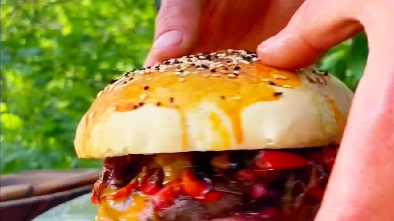 Cooking an unusual burger in the forest on a fire