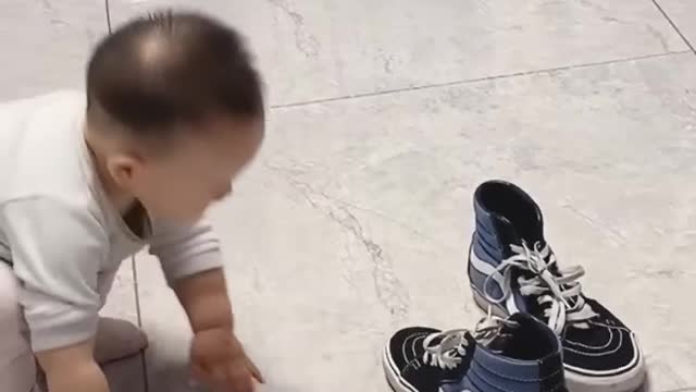 Cute baby try to use shoes. but not use try to different position use to shoe super funny.