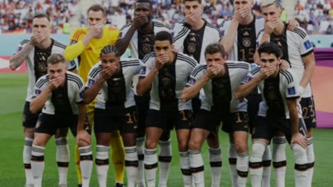 Germany players cover mouths in team photo with minister support