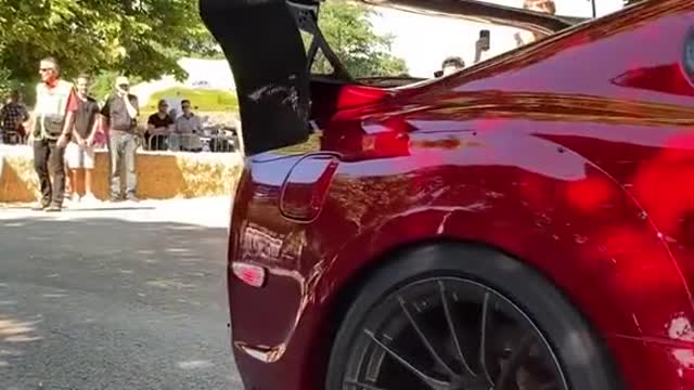 A car with a modified tail at the auto show attracted passers-by.