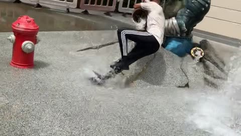 Guy Running Through Fountain Runs into Statue