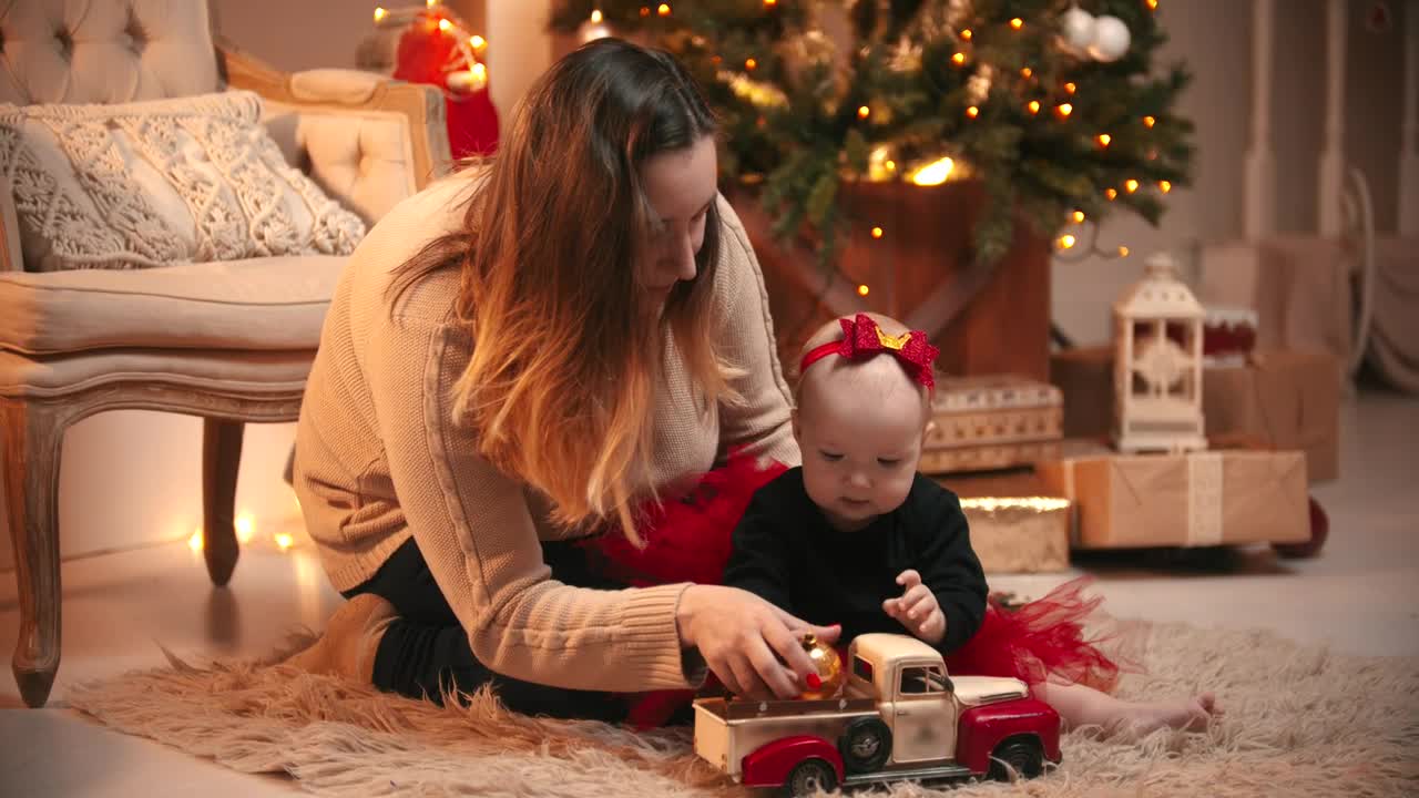 Happy mom with her baby on Christmas night