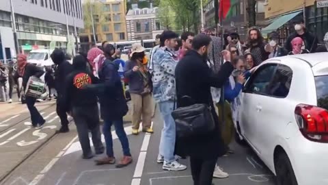 In Amsterdam, far-left protesters block the roads and attack all citizens who pass by in a vehicle.