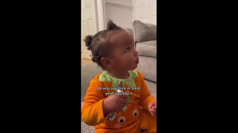 Adorable toddler gets ready for Halloween