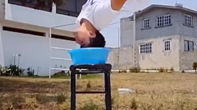 Guy Wets His Hair While Flipping Over Tub of Water