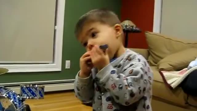 Talented kid plays mouth organ
