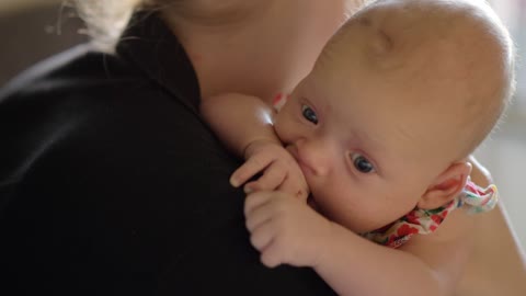 Mother holding her quiet baby