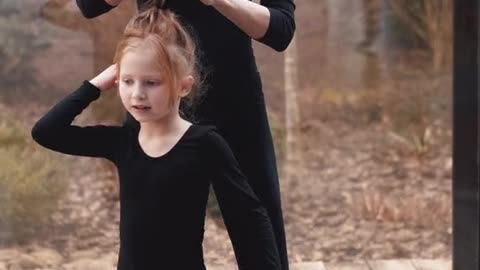 A mother who repairs her child's hair while dancing and exercises,