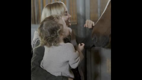 Mother and child have fun with the horse