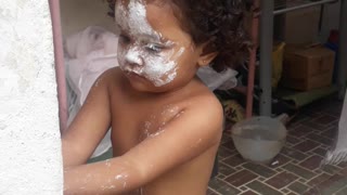 child with a face smeared with flour