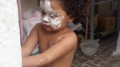 child with a face smeared with flour