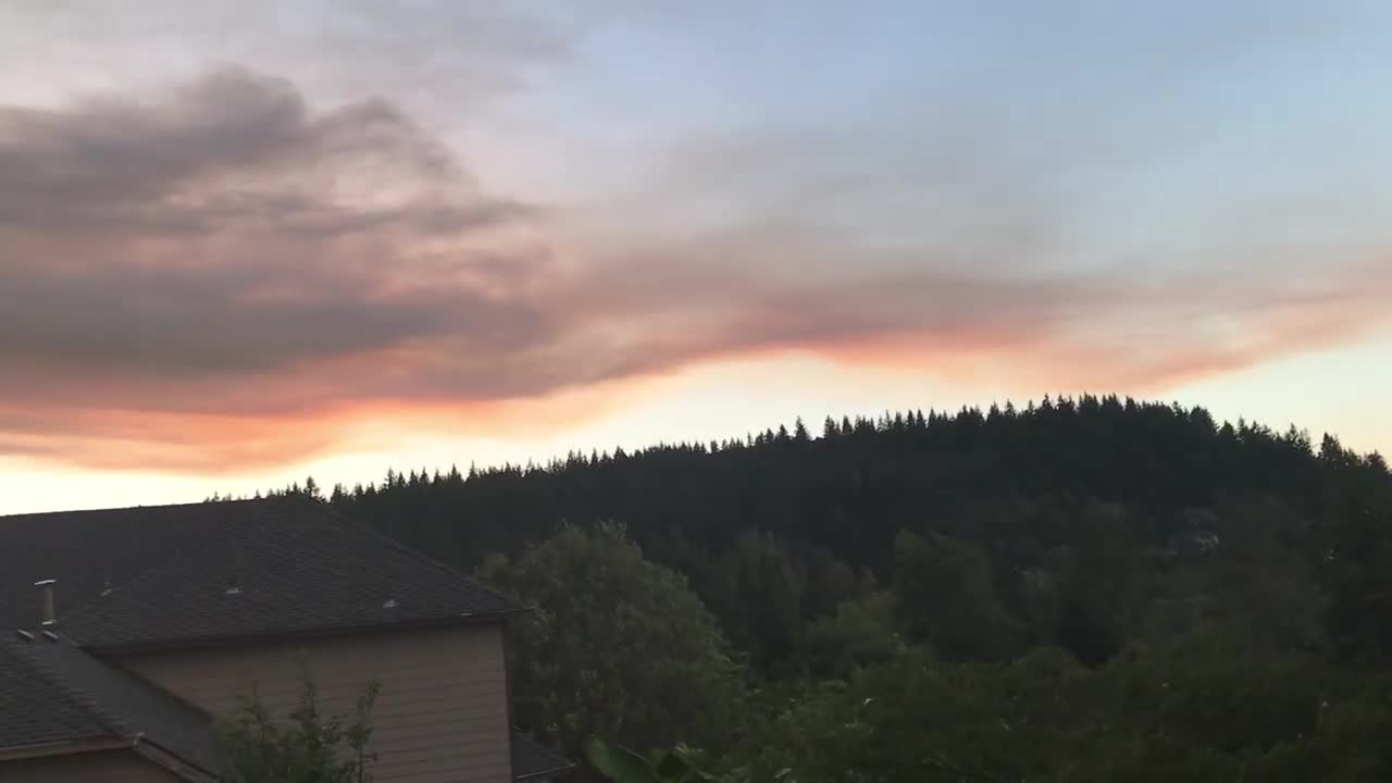 Bands of colored forest fire smoke.