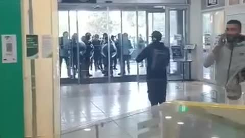 Australian Police surround a building in riot gear and creat the problem