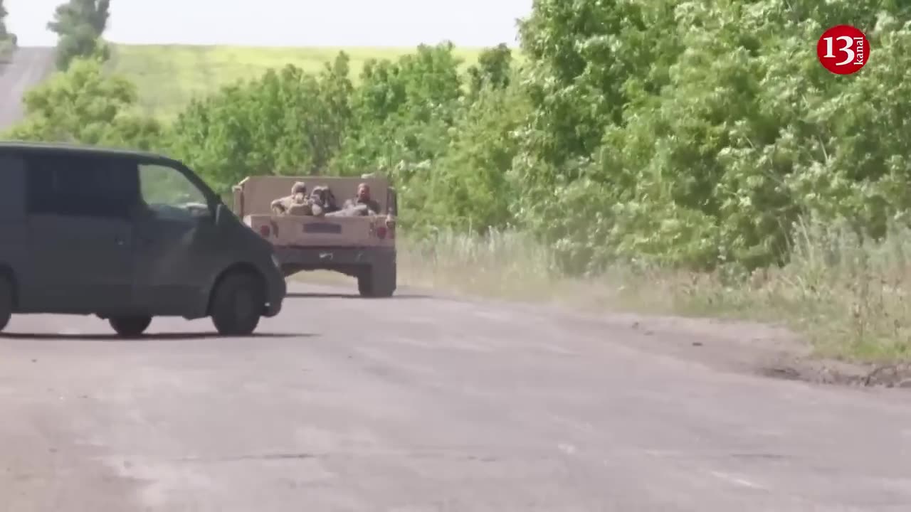 Ukraine military vehicles drive on dusty roads near retaken villages