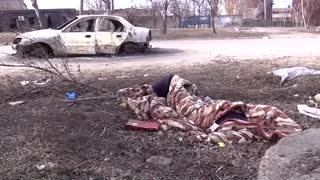 Graves in streets, survivors in basements in Mariupol