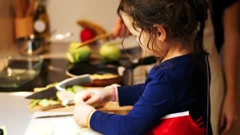 Mother showing he daughter a few things n kitchen bout cooking