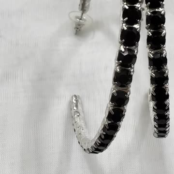 Rhodium Plated 2.75” x 2.5” Hoop Earrings. Made with Swarovski Crystal.