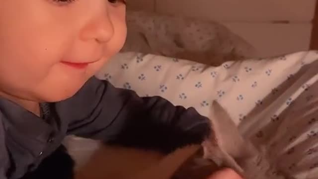 don't miss the cute sight of a little child hugging a cat!