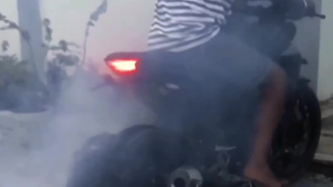 man gets launched on his motorbike when tyre pops doing skid.