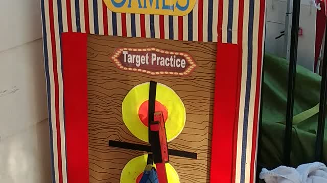 Throw a foam Velcro ax to hit the bullseye at a circus party with ringmaster in Humble Texas