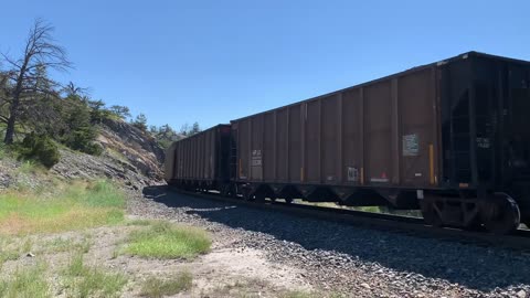 Solid EMD SD70ACe lineup up Mullan Pass. 3 BNSF, 4 MRL, then 1 BNSF on the rear.