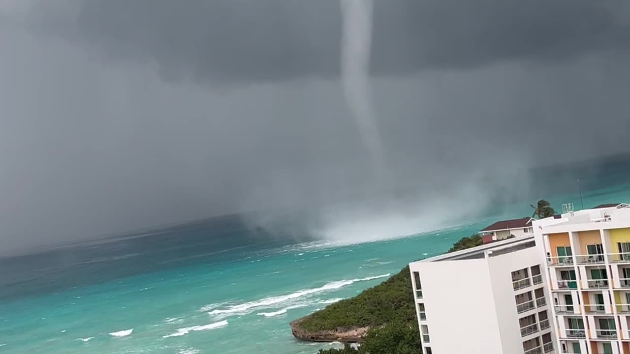 Waterspout Towers Over Shore