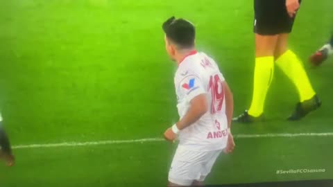 Sevilla defender Marcos Acuna throwing away a note passed onto the pitch by manager Jorge Sampaoli