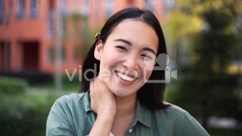 Outdoor Portrait Of A Beautiful Japanese Girl Looking And Smiling At Camera 3