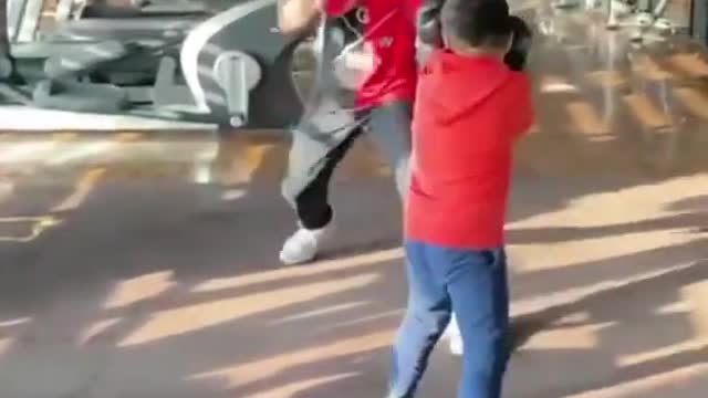 Kid Performs Boxing Drills With Trainer