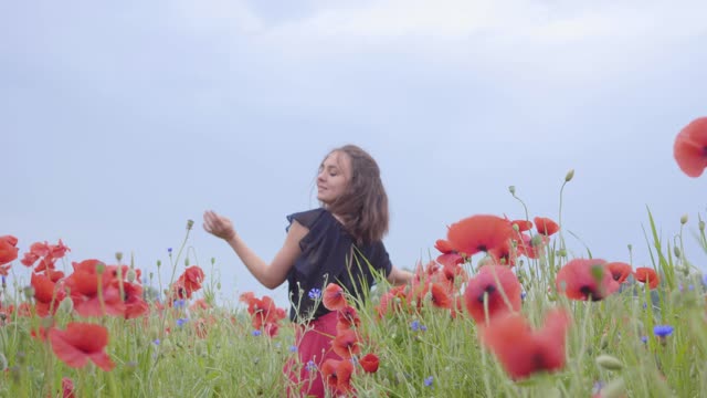 Young Girl moving joyfully in a field of blossoms