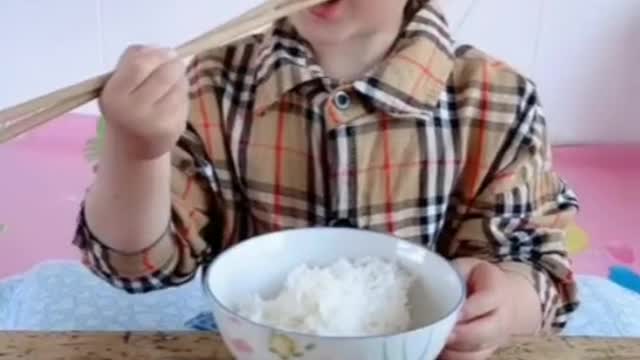 Cute Kid Eating with Sticks