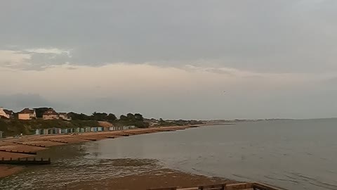 Drone footage. Panning towards the sea