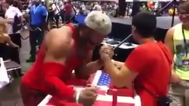 Arm wrestler wins while taking selfie picture! Strength is a skill you acquire,