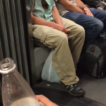 Man in blue with glasses holding teeth