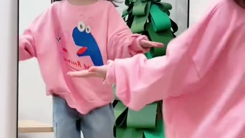 cute baby dancing in front of the mirror