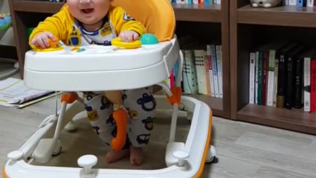 This is a video of a baby practicing walking using a device.