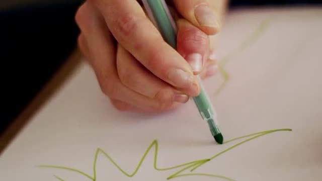 A Mother Guiding Her Daughter Hands In Drawing A Christmas Tree