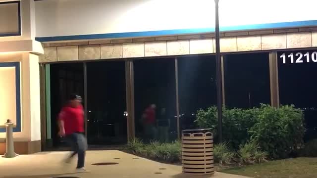 Guy in red jumps over trash can