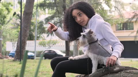 Pet owner spending time with his little dog in a park